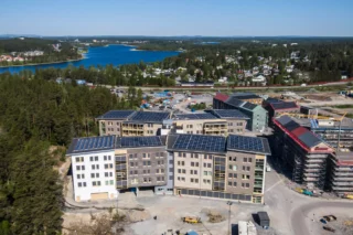 Kronan, Luleå, vård- och omsorgsboende, fotofraferat från luften. De två byggnaderna är fyra våningar höga och fasaden är i beige och vitt. I bakgrunden ses havet.