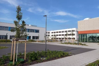 the white school building in Zossen, Germany and in the right corner the gym is visible.