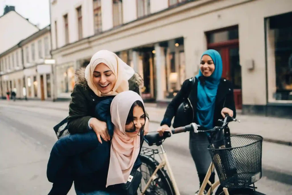 Three friends with bikes in the city, going home from school.